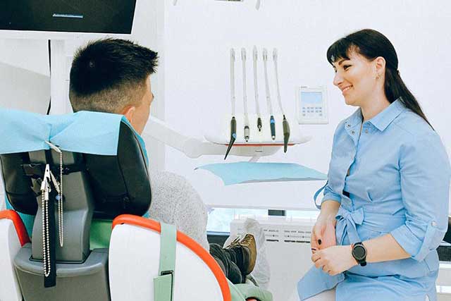 A dental assistant with a patient.