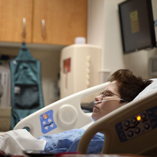 woman resting in hospital bed