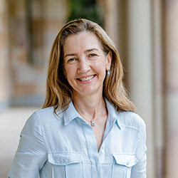 Profile photo of Dr Sue McAvoy standing in the UQ Great Court