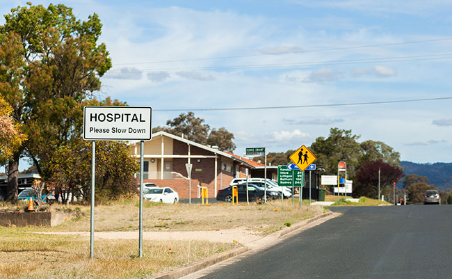 Hospital please slow down sign in small country town before hospital building