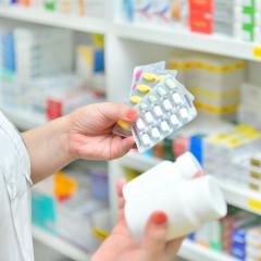 Pharmacist choosing between multiple medicines. 