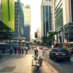 slightly blurry photo of traffic and pedestrians on a Brisbane city street