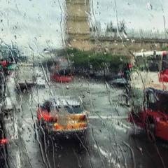 rain on a window looking at a busy street