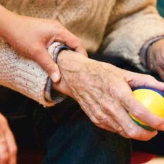 holding an older person's hand