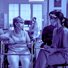 Woman talking with medical staff in hospital 